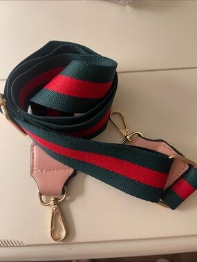 Adjustable Green and Red Stripe purse strap with gold color hardware.